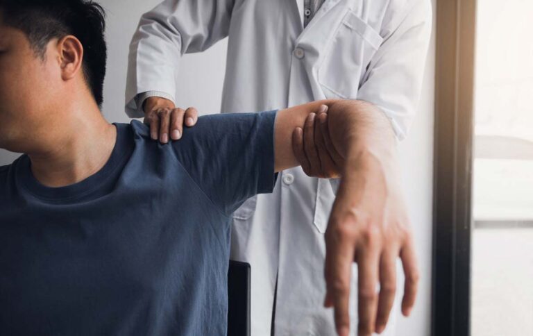 man getting physical therapy on shoulder