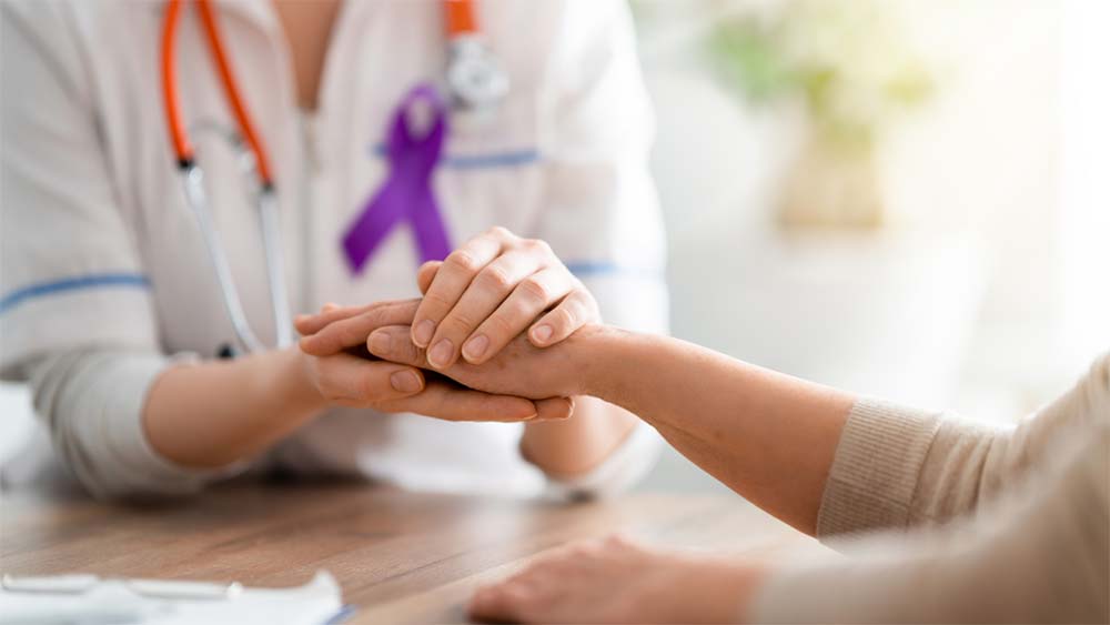 patient and doctor holding hands