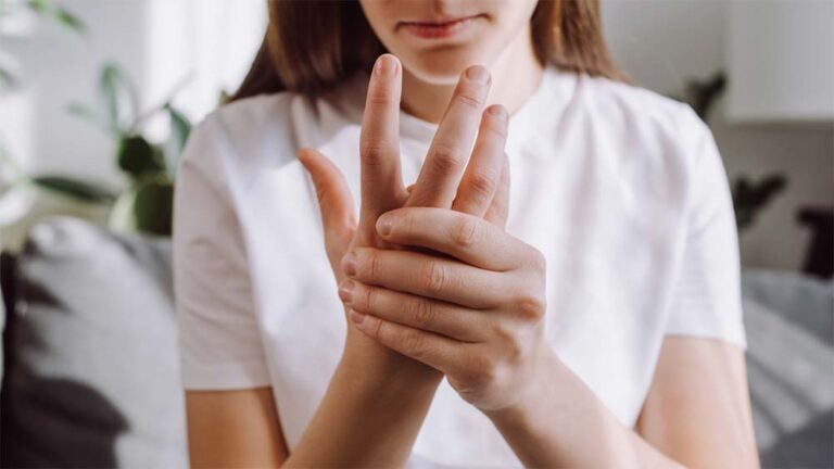 Woman holding hand in pain