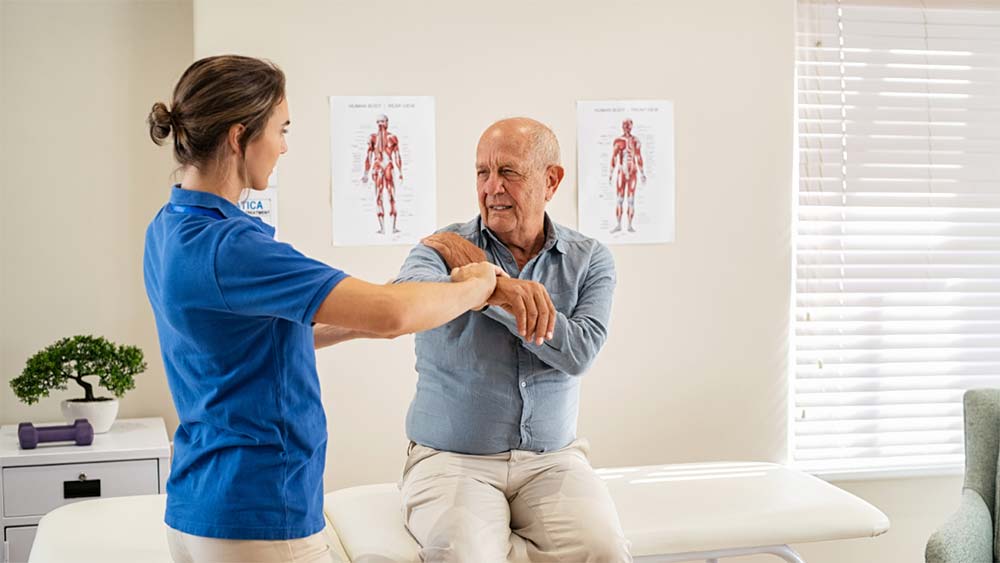 doctor working with patient with shoulder pain